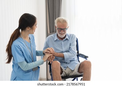 Nurse And Patient Senior Man On Wheelchair. Nurse Caring Senior Man Sitting On Wheelchair At Hospital. Asian Nurse Taking Care Old Man In Wheelchair At Home.