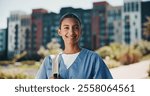 Nurse portrait, healthcare and woman outdoor for health training program, medicine study or hospital residency. Medical school, student and happy with backpack on campus for education and career path