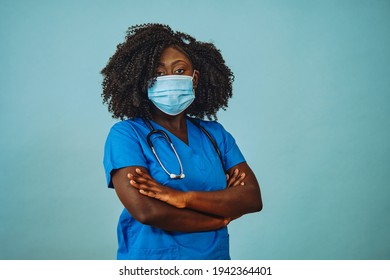 Nurse practitioner doctor with face mask and crossed arms