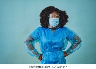 Nurse practitioner with personal protective equipment hands on hips covid 19