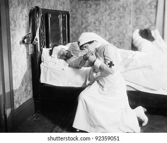 Nurse Praying For An Outlaw Lying In Bed