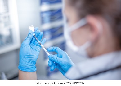 The Nurse Prepares The COVID-19 Vaccine For The Patient. She Uses Safety Measures And She Calculates The Correct Dose.