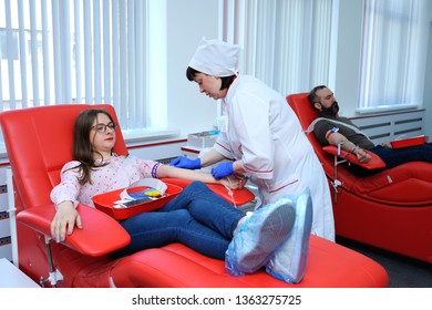 Nurse Preparing A Donor For Taking Blood From The Vain. The City (municipal) Blood Transfusion Station. April 5, 2019. Kiev, Ukraine