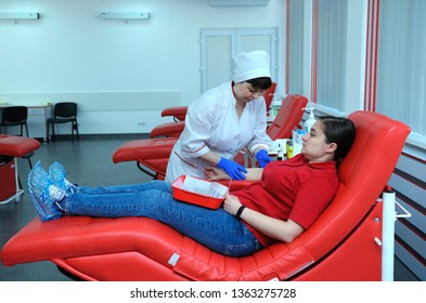 Nurse Preparing A Donor For Taking Blood From The Vain. The City (municipal) Blood Transfusion Station. April 5, 2019. Kiev, Ukraine