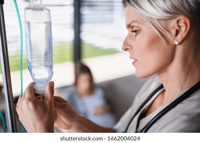 A Nurse Preparing IV Drip In Hospital Or At Home.