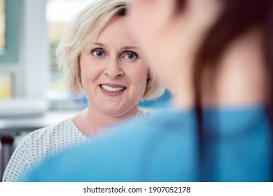 Nurse preparing patient for the coming surgery by explaining what will happen