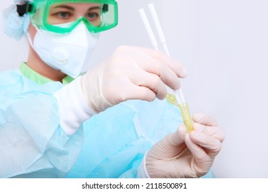 Nurse in a protective mask does a PCR test for covid-19. PCR test for covid-19. Clinical laboratory. High-precision diagnostics. The nurse's face is out of focus. - Shutterstock ID 2118500891