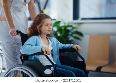 Nurse pushing little girl on wheelchair at hospital corridor. - Powered by Shutterstock