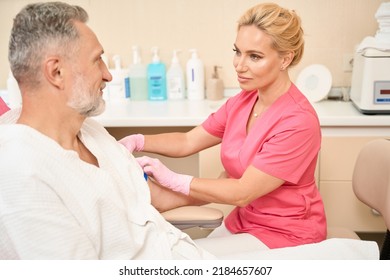 Nurse Puts A Tourniquet On His Shoulder Before Taking Blood