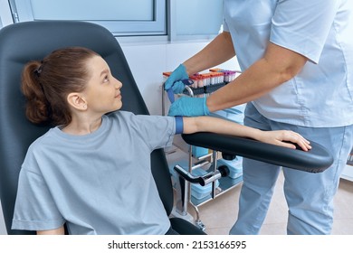 A Nurse Puts A Tourniquet On A Little Girl's Hand