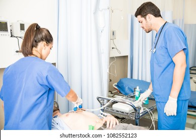 Nurse Putting ECG Electrodes On The Chest Of Patient With Doctor Setting The Machine In Hospital Emergency Room