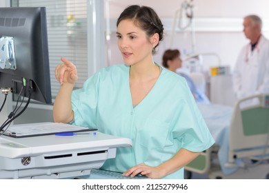 a nurse reading computer screen