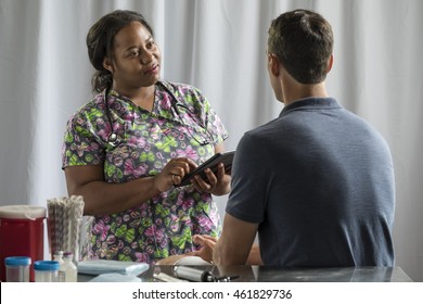 Nurse receiving medical history from male patient