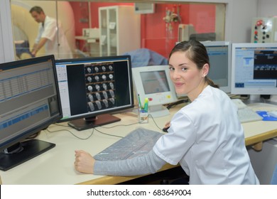 Nurse At Reception Desk In Hospital