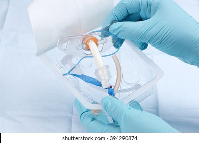 Nurse removes 6mm endotracheal tube from package.