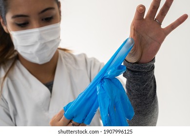 Nurse Removing Latex Gloves After Caring For A Covid Patient