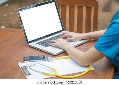 Nurse searching for something using her computer
