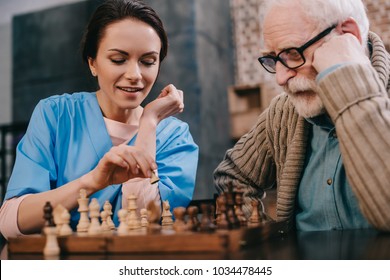 Nurse And Senior Man Passionate About Chess