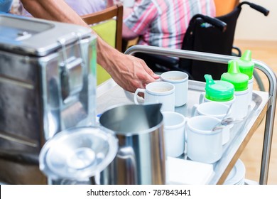 Nurse Serving Food To Seniors In Nursing Home