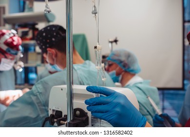 Nurse sets the patient's dropper on the background operation - Shutterstock ID 1316582402