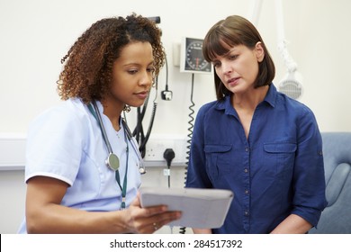 Nurse Showing Patient Test Results On Digital Tablet