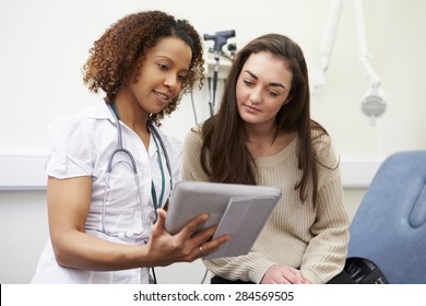 Nurse Showing Patient Test Results On Digital Tablet