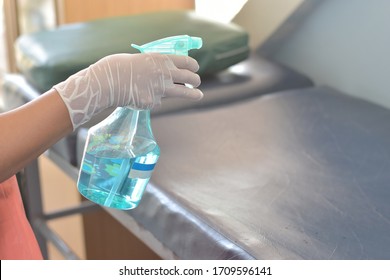 Nurse Spaying Alcohol For Cleaning Bed  In The Hospital.