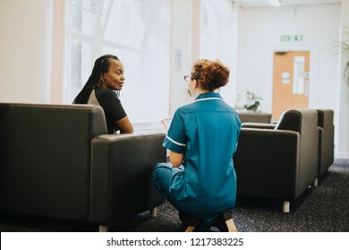 Nurse Speaking To A Patient In The Waiting Room