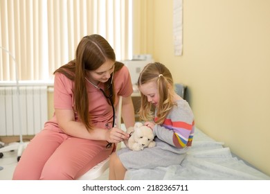 Nurse With Stethoscope Entertains 4 Year Old Girl In Clinic