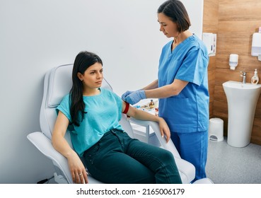 Nurse Taking Blood For Allergen Testing By Collecting Blood In Test Tubes At Laboratory