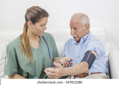 Nurse taking the blood pressure of elderly man