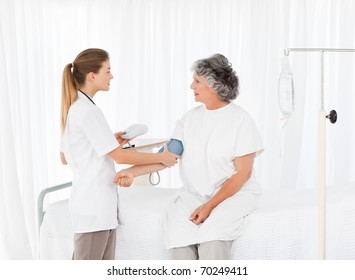 Nurse Taking The Blood Pressure Of Her Patient