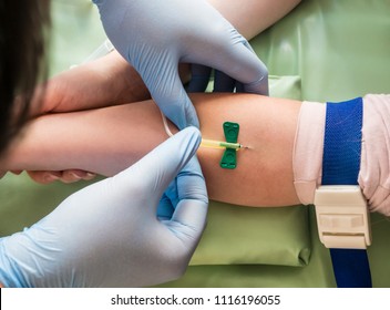 Nurse Taking Blood Sample From A Vein Of A Child