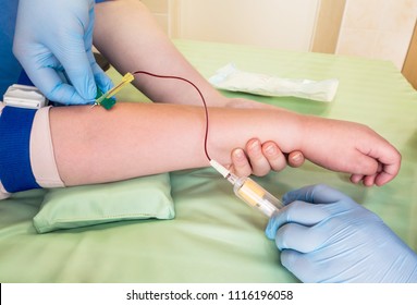 Nurse Taking Blood Sample From A Vein Of A Child