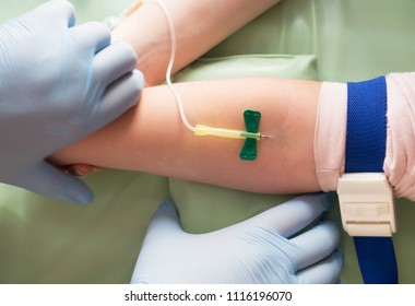 Nurse Taking Blood Sample From A Vein Of A Child