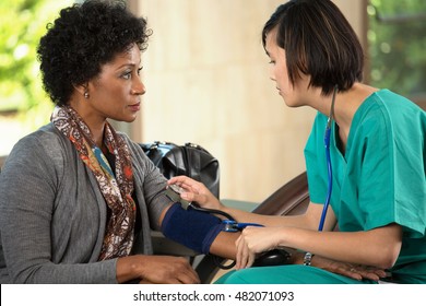 Nurse Taking A Patients Blood Pressure. 