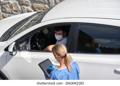 Nurse Taking A Young Driver's Data Before Vaccination