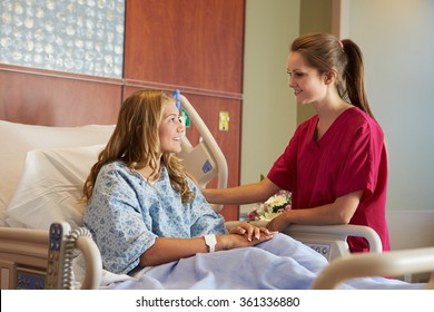 Nurse Talking To Female Teenage Patient In Hospital