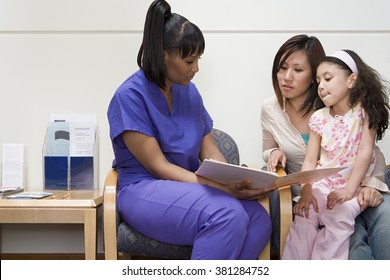 Nurse talking to mother and daughter
