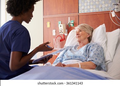 Nurse Talking To Senior Female Patient In Hospital Bed