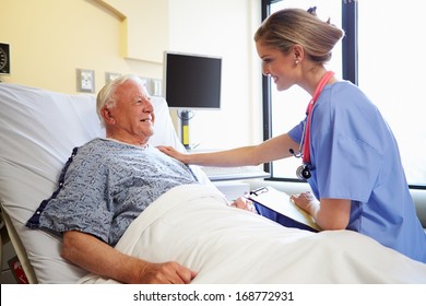 Nurse Talking To Senior Male Patient In Hospital Room