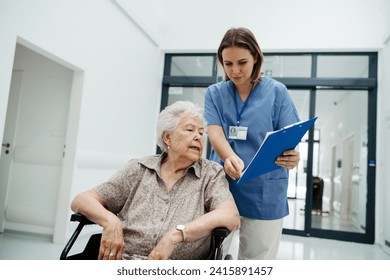 Nurse talking with senior woman, admitting a patient to the hospital, filling documents. Discharging of elderly patient. after surgery. - Powered by Shutterstock