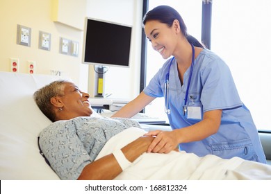 Nurse Talking To Senior Woman In Hospital Room