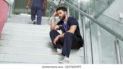 Nurse, thinking and man with stress, depression and sad to regret patient loss on steps in hospital. Surgeon, professional and anxiety for medical fail, mental health challenge or mistake in clinic - Powered by Shutterstock