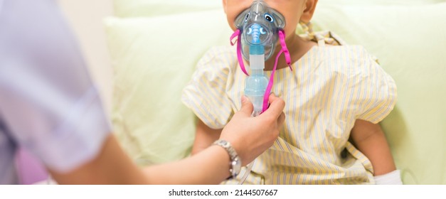 Nurse treat admitted patient boy by inhalation therapy with mask of inhaler. Sick little kid with RSV ,Respiratory Syncytial Virus, problem with oxygen mask breathes through nebulizer at hospital. - Shutterstock ID 2144507667