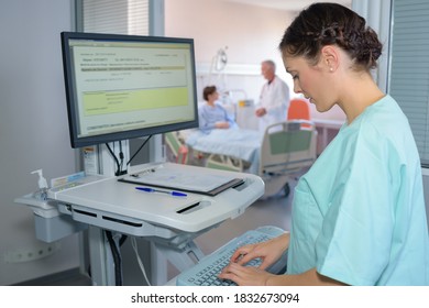 Nurse Typing On Computer Keyboard