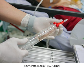 Nurse Use Glass Syringe To Irrigate Nasogastric Tube In Patient With Gastrointestinal Bleeding