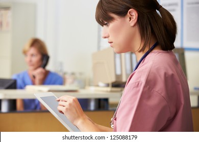 Nurse Using Digital Tablet At Nurses Station