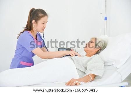 Similar – Caregiver auscultating senior woman