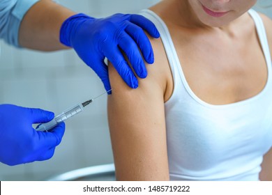 A Nurse Using Syringe For Vaccination A Patient In Hospital During An Epidemic Of Influenza, Measles And Viral Infections. Flu Shot